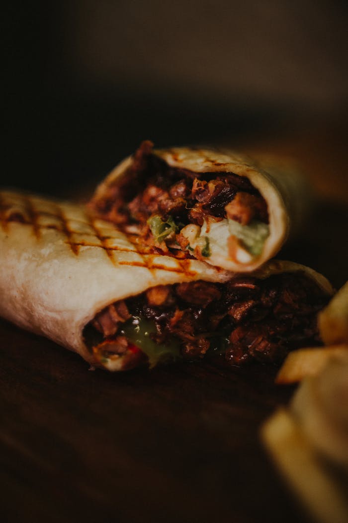 Close-up of a tasty grilled burrito with meat and vegetables, perfect for lunch.